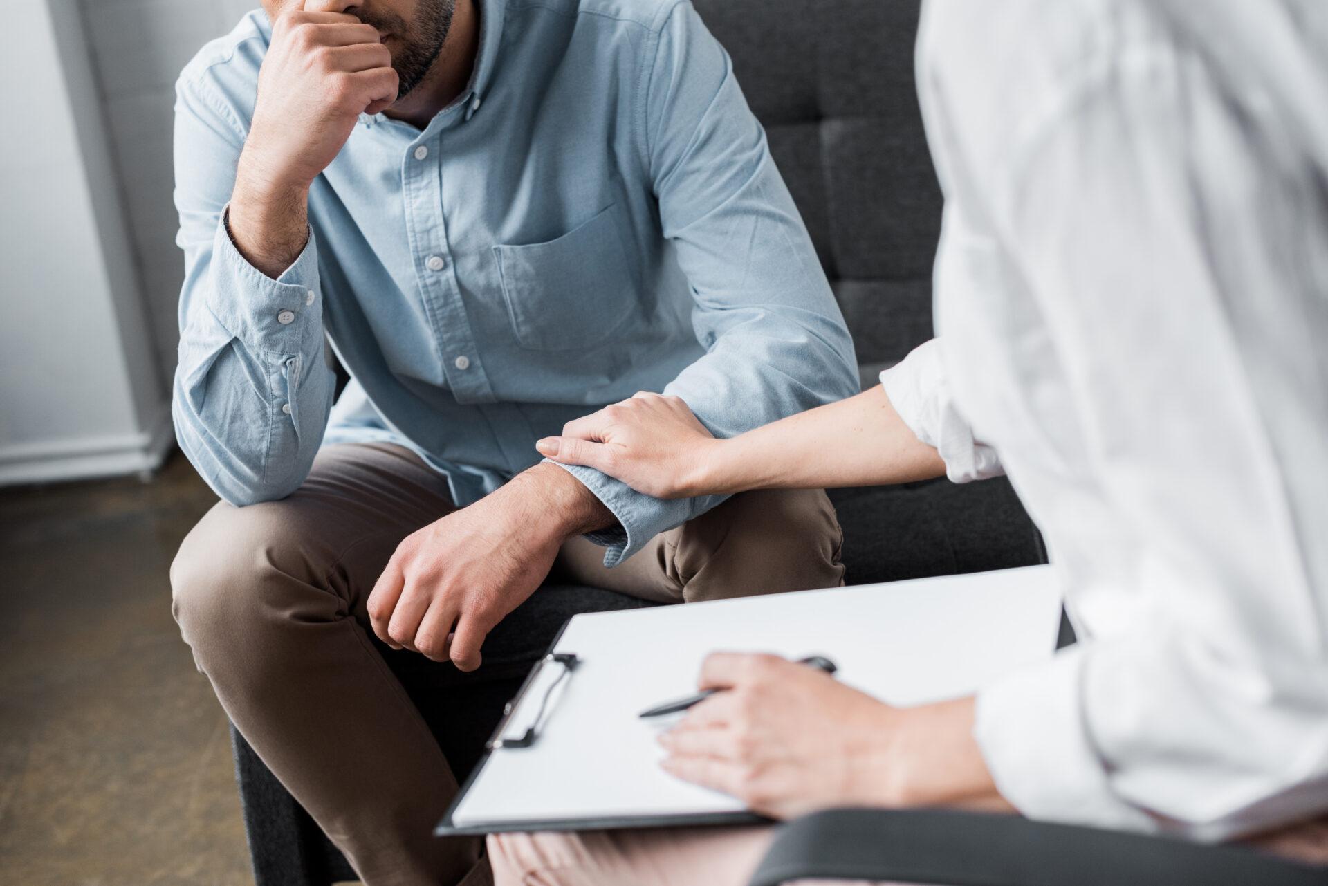 Therapist taking notes during a counseling session