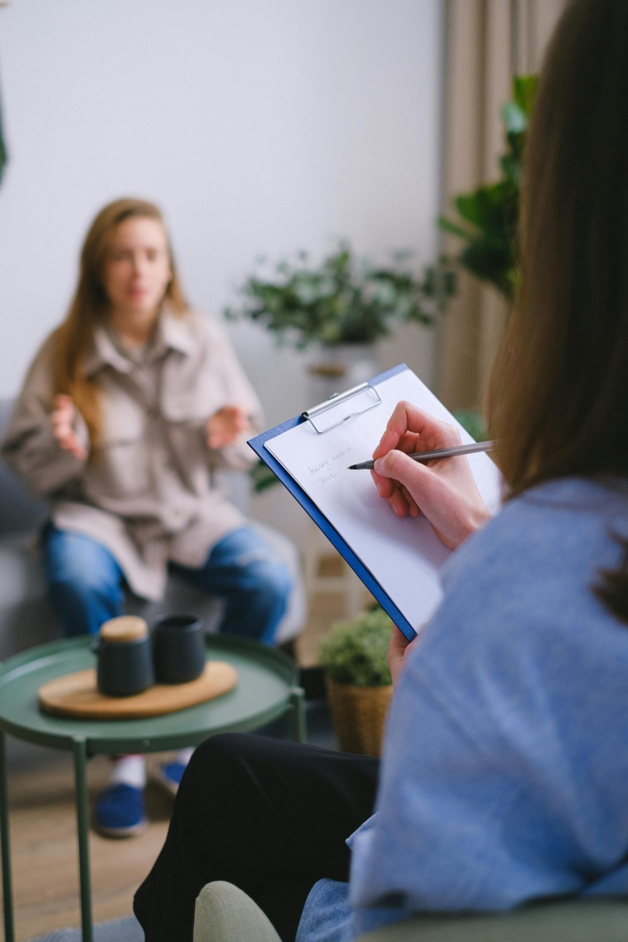 A therapist taking notes during a one-to-one session