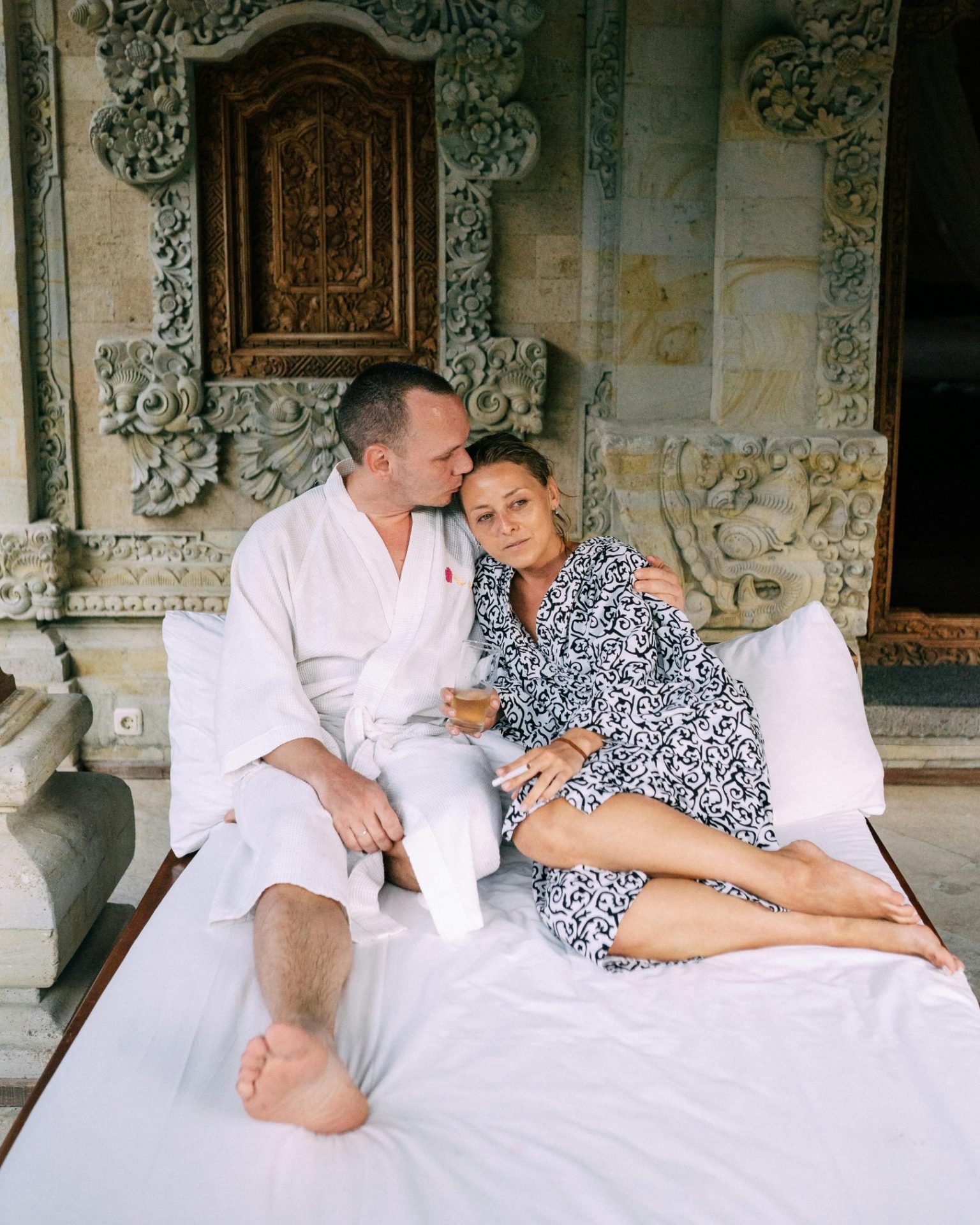 A couple embracing on a bed