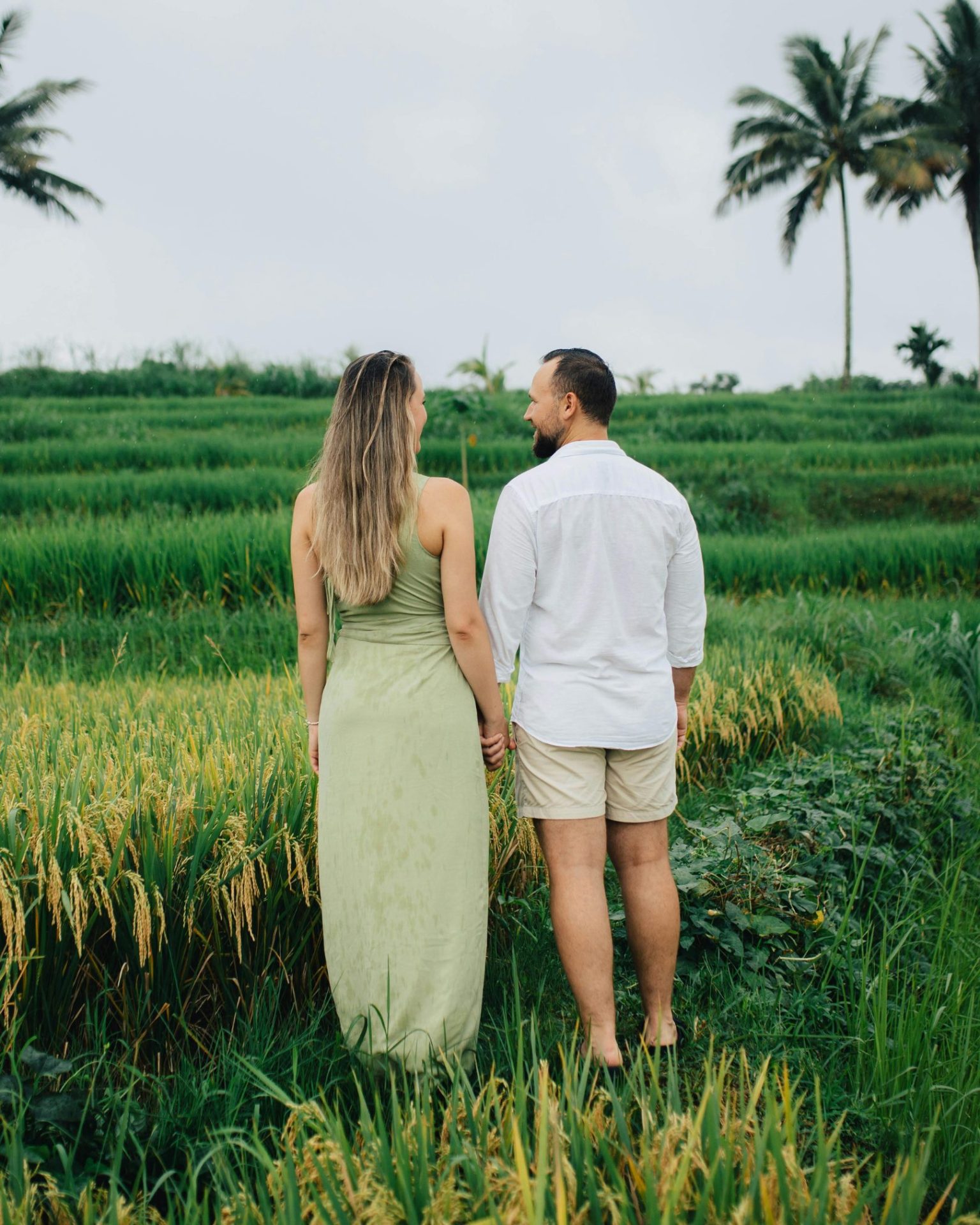 A couple standing in a green field