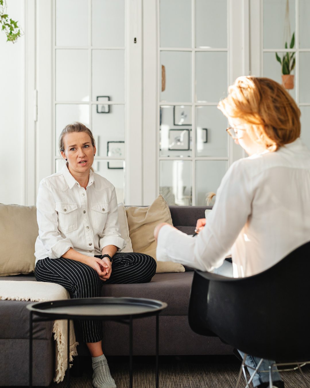 A therapy session at our practice — client talking with her therapist
