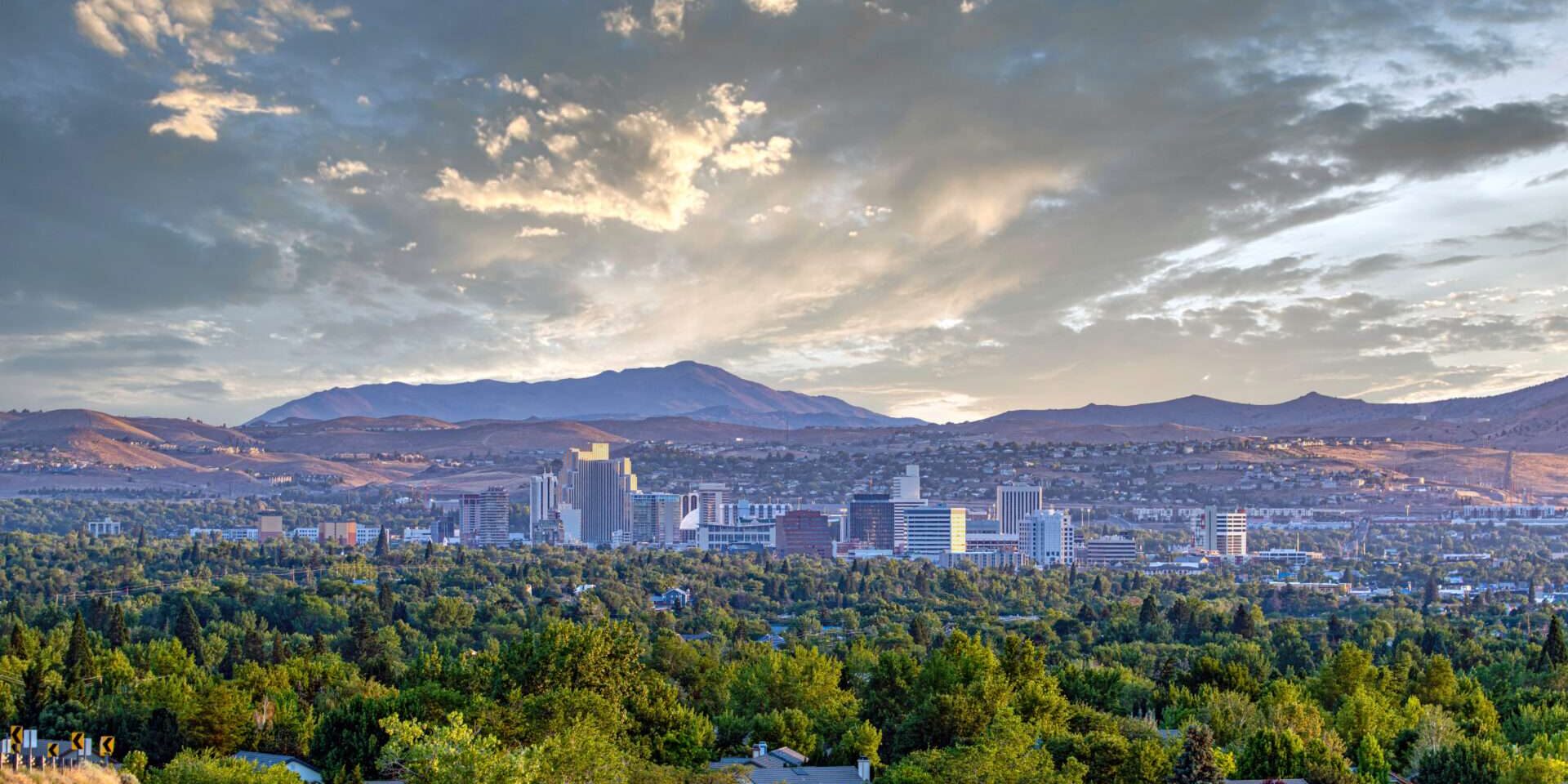 Downtown City of Reno cityscape with hotels and casinos and a dramatic sunrise. image of Reno, NV, home of therapists at Individual & Relationship Counseling Associates