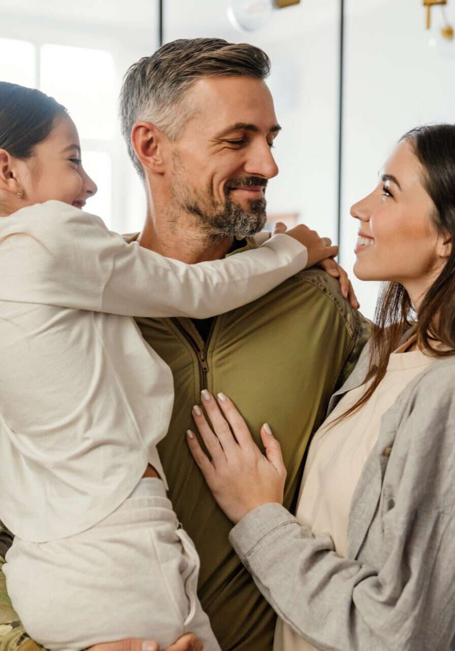 Happy couples counseling clients with young daughter Happy couple with military husband. Emotionally Focused Couples Therapy (EFT) Reno